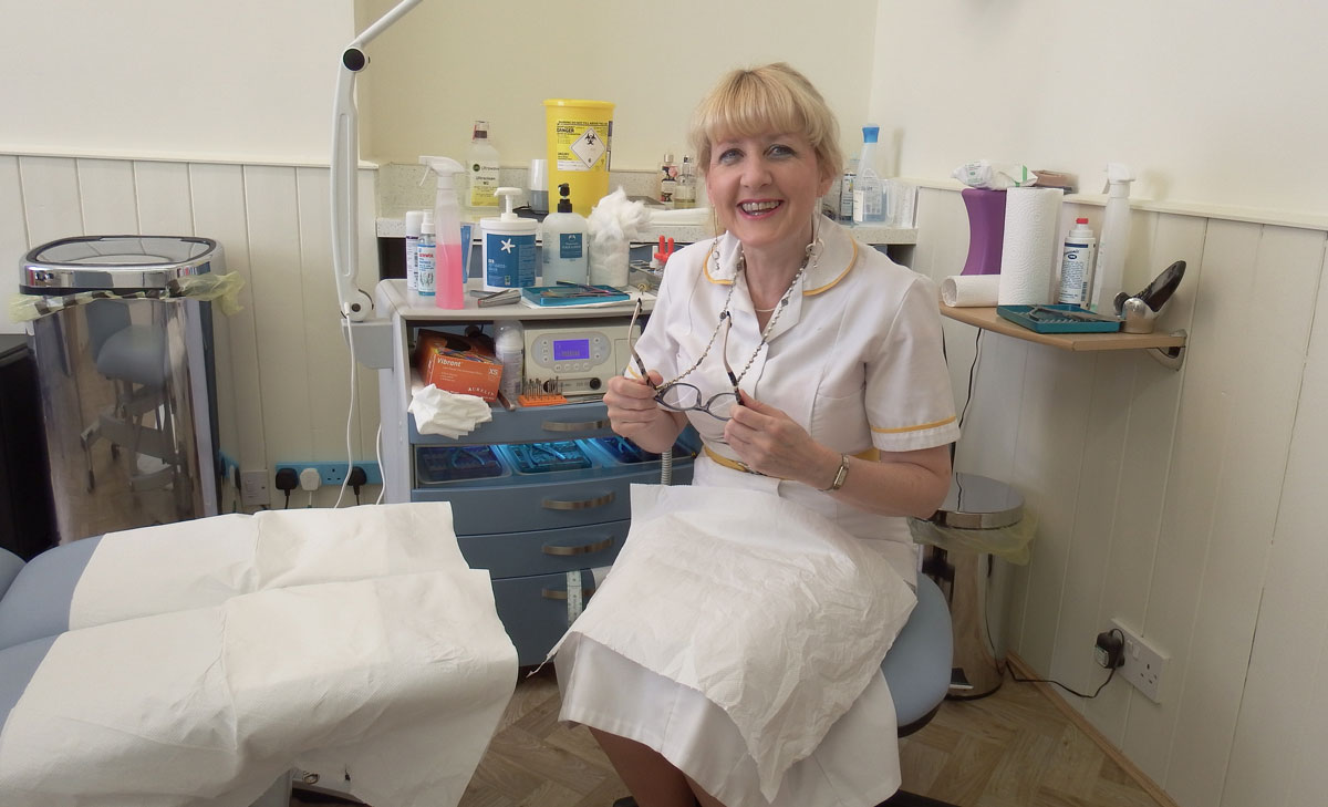 Carol Wilson Podiatrist in Blue Chiropody room